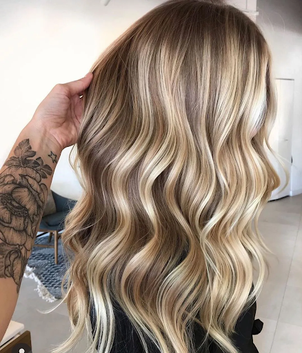 You can use semi-permanent hair color to tone down your highlights. 